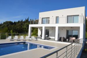 a villa with a swimming pool and a house at Villa Kefalonian Dream in Minia