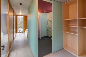 a bathroom with green walls and a walk in shower at Bern Youth Hostel in Bern