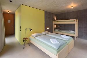 a bedroom with a large bed and a yellow wall at Bern Youth Hostel in Bern