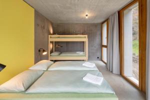 a bedroom with two beds in a room with yellow walls at Bern Youth Hostel in Bern