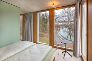 a bedroom with a bed and a large window at Bern Youth Hostel in Bern