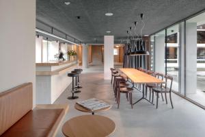 a dining room with a long table and chairs at Bern Youth Hostel in Bern