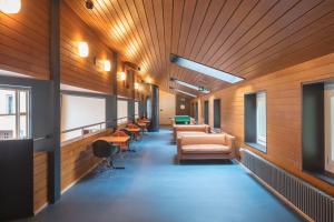 a hallway with chairs and tables in a building at Bern Youth Hostel in Bern