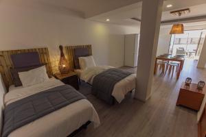 a hotel room with two beds and a table at Surf Loft Open Space in Ericeira