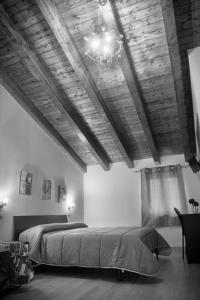 a bedroom with a large bed and a chandelier at Asaro Camere in Campobello di Licata