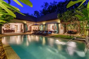 a swimming pool in the backyard of a house at Inspire Villas Phuket in Rawai Beach