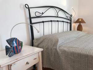 a bedroom with a bed and a table with a nightstand at Oklacà Patmos Beach Rooms in Patmos