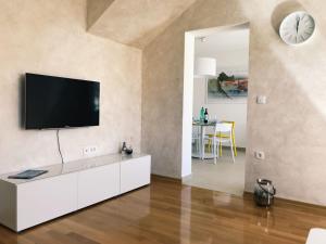 a living room with a flat screen tv on a wall at SiMa in Baška Voda