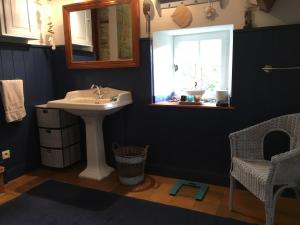 baño con lavabo, espejo y ventana en Les Rivieres, en Caumont-sur-Orne