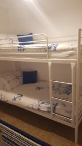 a couple of bunk beds in a room at Relaxed Space in the beach in Puerto de Sagunto