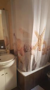 a bathroom with a sink and a shower curtain at Relaxed Space in the beach in Puerto de Sagunto