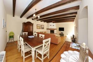 a living room with a table and chairs and a couch at Olive's Hug in Poljana