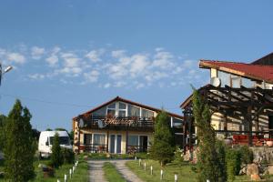 a large house with a fence next to it at Pensiunea Maria Sibiu in Sibiu