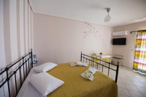 a bedroom with a bed with two towels at Alexandros in Lefkada