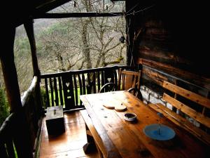 a wooden table on the porch of a cabin at Apartment Cerova Kosa in Mokra Gora