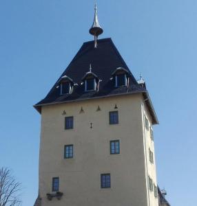 a tall building with a roof on top of it at Turmapartment Lindenhof in Millstatt
