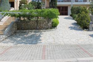 a stone walkway in front of a building at Apartments Vila Marica in Rabac