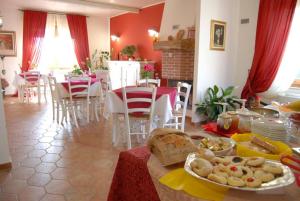 cocina y comedor con mesa y comida en Agriturismo La Biandrina, en Carpignano Sesia