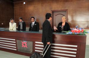 a group of people standing behind a reception desk at Kabul Star Hotel & Restaurant in Shīrpūr