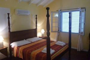 a bedroom with a bed and a window at Villa Laurencin in Sainte-Rose +27 photos