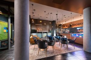 a living room filled with furniture and a tv at Bo18 Hotel Superior in Budapest