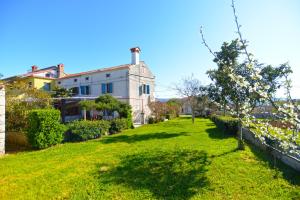 a house on a hill with a green yard at House Angela 1585 in Rakalj