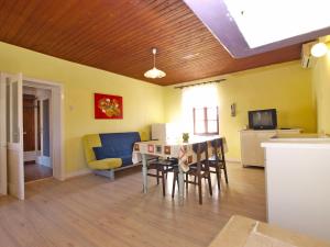 a kitchen and dining room with a table and chairs at House Angela 1585 in Rakalj