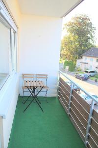 a table on a balcony with a view of a street at Ferienwohnung Engel Lindau am Bodensee in Lindau