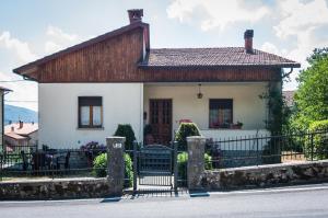 uma pequena casa branca com um telhado de madeira em La Verna House em Chiusi della Verna