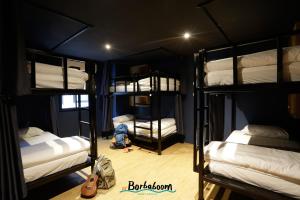 a room with four bunk beds in a room at Borbaboom Phuket Poshtel & Hostel in Phuket Town