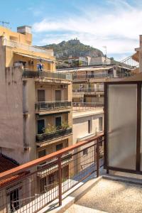 a balcony with a view of some buildings at 5th floor apartment with city view in Athens
