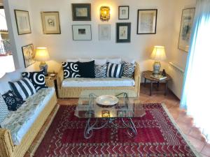 a living room with a couch and a table at BellaVista Apartments in Taormina