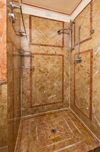 La salle de bains est pourvue d'une douche avec une porte en verre. dans l'établissement DB Villas Le Ville del Lido Resort, sur le Lido de Venise