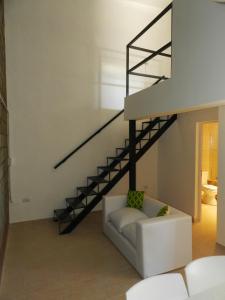 a living room with a staircase and a white couch at Alta Patagonia Apart in Viedma