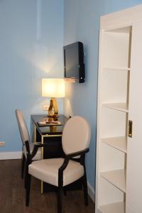 a room with a desk with a chair and a lamp at Atel Hotel Lasserhof in Salzburg