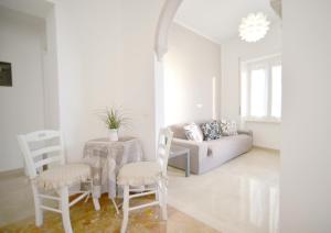 a living room with a table and chairs and a couch at Villa Mori in Levanto