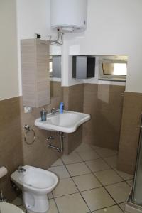 a bathroom with a sink and a toilet at Il Fortino in Catania