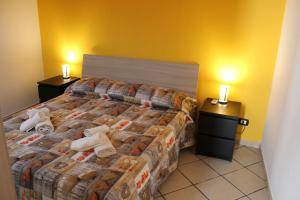 a hotel room with a bed with towels on it at Il Fortino in Catania