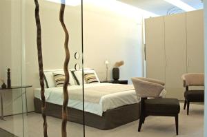 a bedroom with a bed with a glass wall at Maison Wyck in Maastricht
