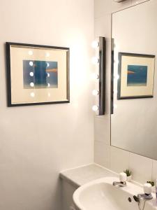 a bathroom with a sink and a mirror at Bishopton Apartment, near Glasgow in Bishopton +12 photos