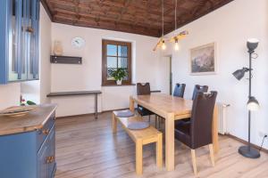 a kitchen and dining room with a wooden table and chairs at Rudolfshöhe in St. Wolfgang