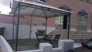 a patio with a table and chairs under an umbrella at Lisbon Hostel Terminal 3 in Lisbon