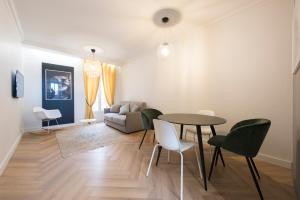 a living room with a table and chairs and a couch at F2 chambre en duplex (calme) plein centre ville 1 min de la plage in Saint-Raphaël