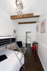 a bedroom with a bunk bed and a desk at Aux Portes d'Honneur in Cluny