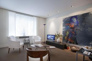 a living room with a large painting on the wall at Maison Wyck in Maastricht