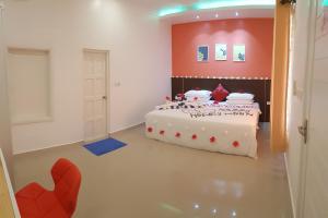 a bedroom with a bed with hearts on it at Scuba Inn in Omadhoo