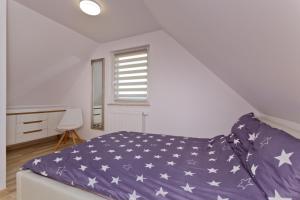 a bedroom with a bed with an american flag bedspread at Domki OAZA in Ostrowo