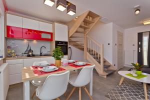 a kitchen and dining room with a table and chairs at Domki OAZA in Ostrowo +31 photos