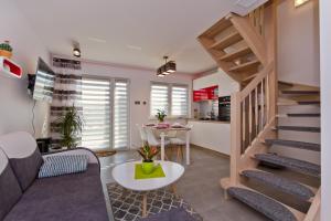 a living room with a staircase and a table at Domki OAZA in Ostrowo