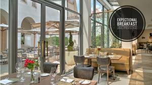 a restaurant with tables and chairs and a sign that reads exceptional breakfast at President APT by Prague Castle, VIEWS in Prague